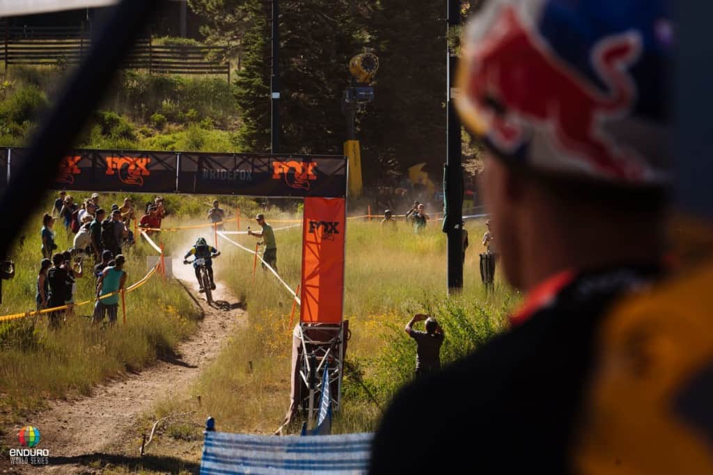 Sam Hill approaches the finish line as Richie watches on anxiously